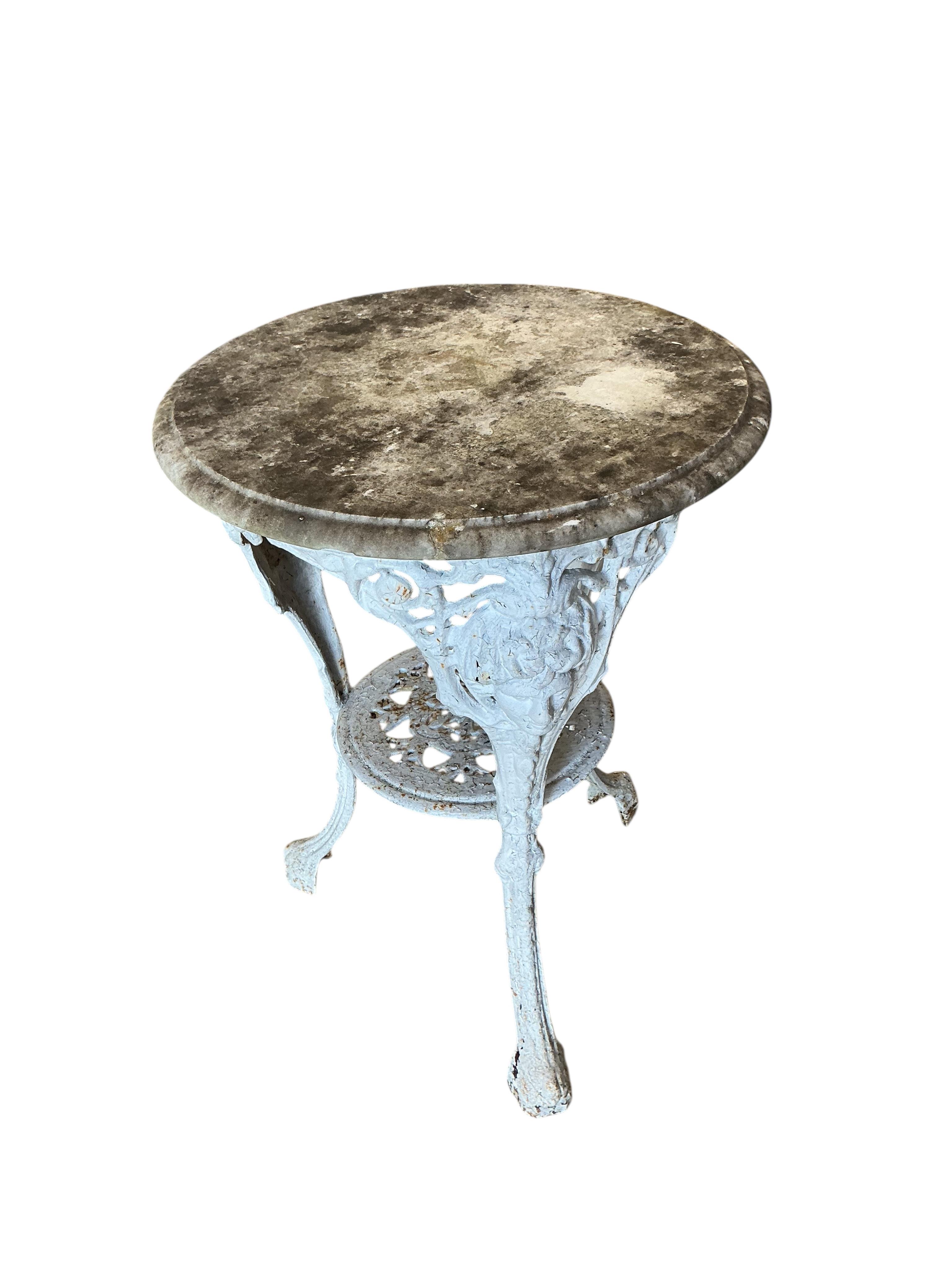 A Victorian cast iron circular marble top table, diameter 50cm, height 70cm